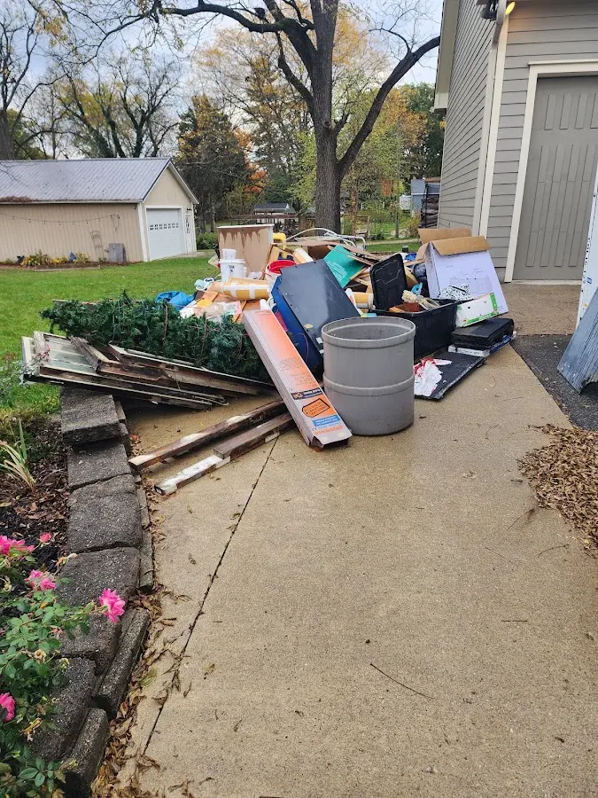 Dumpster being loaded with debris for Residential Dumpster Rental in Sutton
